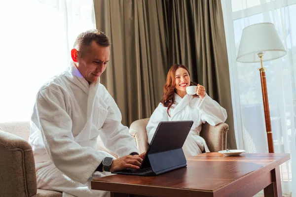 Imagen de joven pareja que se encuentra reservando su masaje mediante el uso de un software SPA para hoteles especializado.